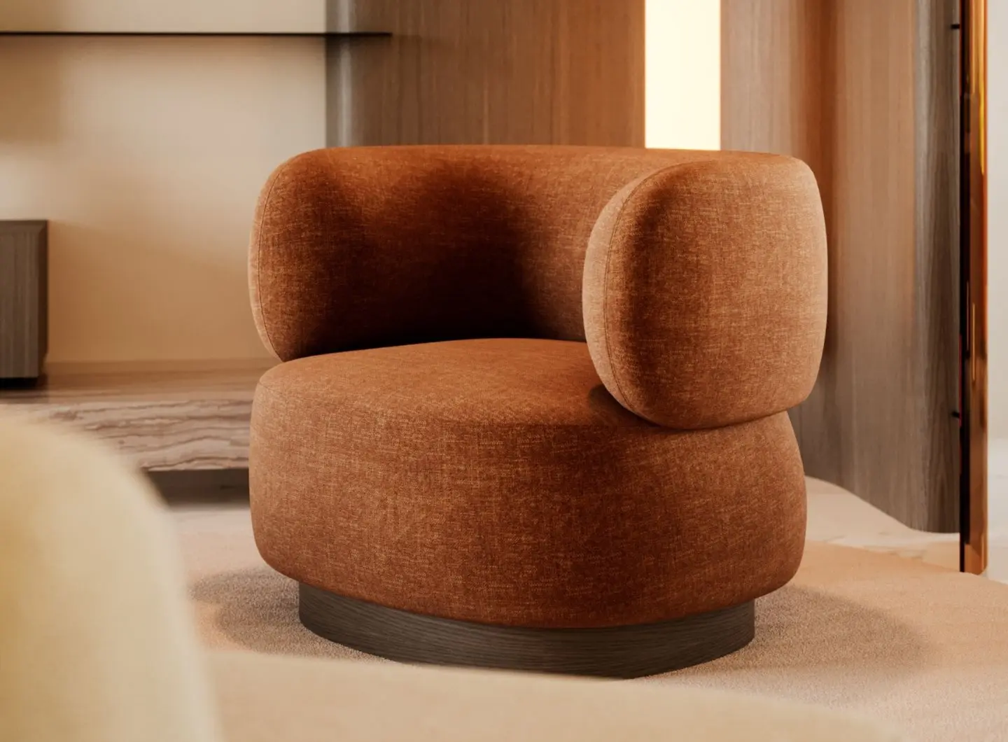 The Dolomites Armchair is shown in rust‑colored upholstery with a curved integrated back and armrest, resting on a dark circular base in an elegant interior with warm lighting and wood paneling.