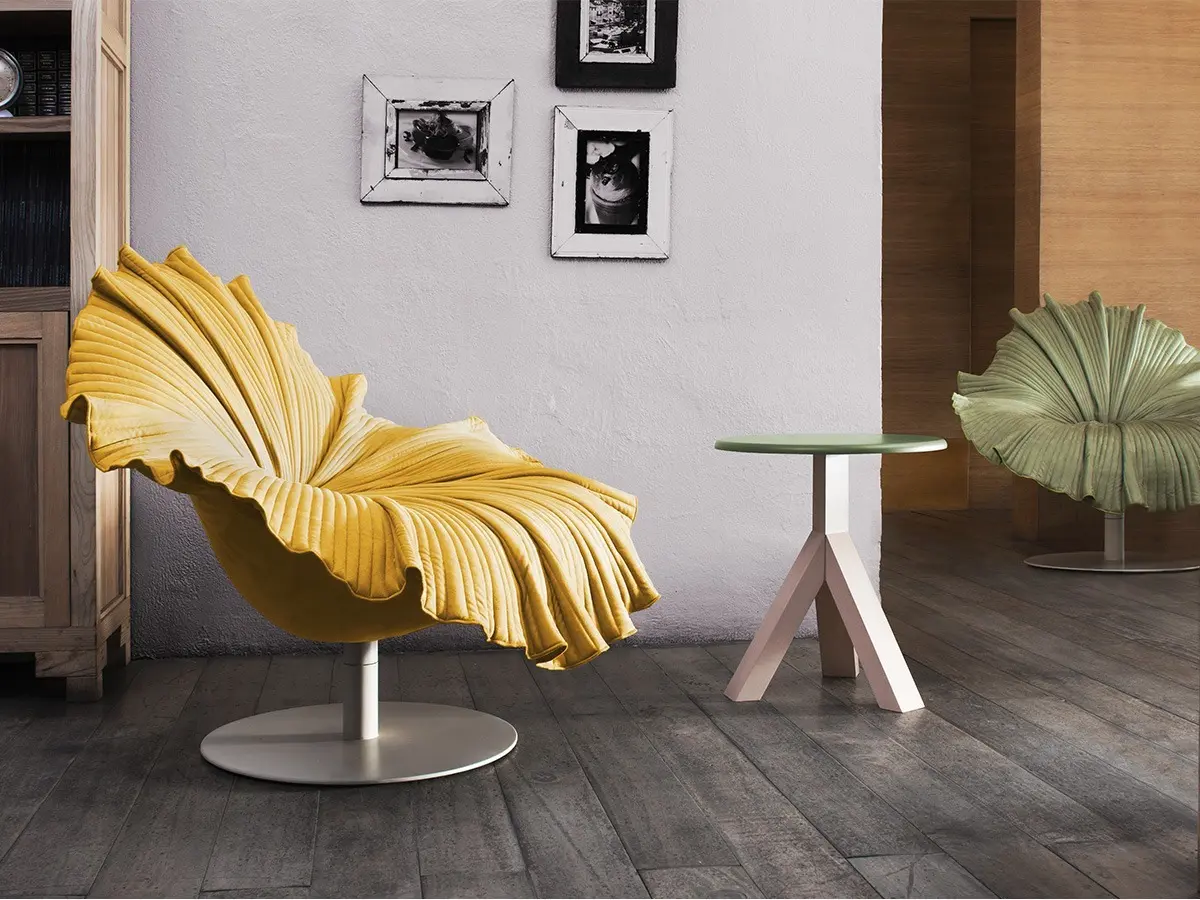 The BLOOM Easy Armchair is a KENNETHCOBONPUE classic. Velvet fabrics are carefully shaped and folded by hand to mimic the elegance of a blossoming flower. Its swivel base allows easy 360 movement and shaded in a simple hue to pronounce the vivid color of the BLOOM's petal-like figure.